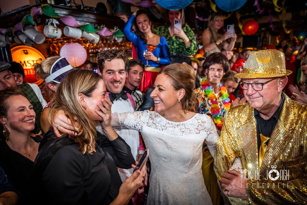 De bruid lacht met haar vriendinnen op het verkleedfeest